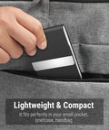 Slim RFID Blocking Card Holder In Black Carbon PU Leather And Stainless Steel With Magnetic Closure being placed in a pocket