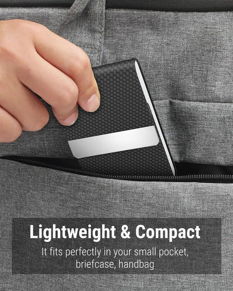 Slim RFID Blocking Card Holder In Black Carbon PU Leather And Stainless Steel With Magnetic Closure being placed in a pocket