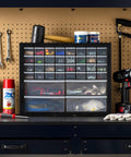 36 Drawer Parts Storage Cabinet For Garage And Workshop Built Tough Organizer For Hardware Screws Nuts Bolts Beads And Craft Supplies Electronics Teacher Toolbox Made In USA Black shown in a workshop setting with tools and supplies.