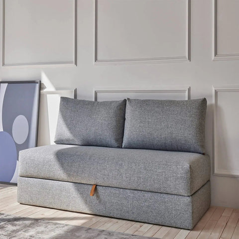 Gray sofa against a wall with white panel molding.