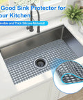 Silicone Sink Mat 24.6 By 13 Inches No Slip Heat Resistant Kitchen Sink Protector For Stainless Steel Sinks Center Drain Grey 1 Pack Flexible Durable Easy To Clean in use in a stainless steel sink.