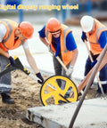 Men using a Tough Foldable Digital Measuring Wheel With Telescopic Shaft And Sweet Backlit Readout Includes Compact Tape Measure at a construction site.