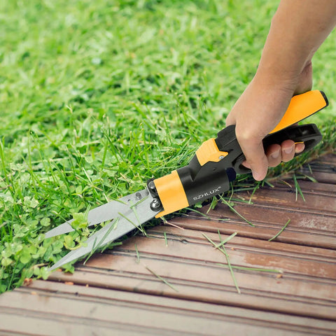 Person using Ultimate 360 Degree Swivel Grass Shears With 5 Inch Stainless Steel Blades for precise lawn edging.