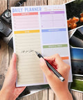 Person writing on a daily planner page of a Portable Memo Pad Notebook For Daily Use With No Residue After Tearing.