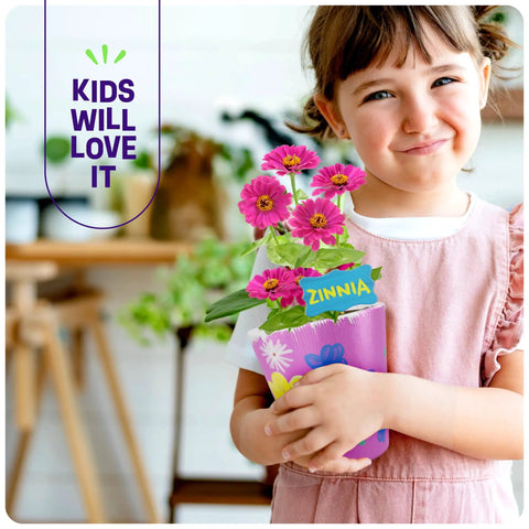 Child holding decorated pot with pink zinnias, part of the Paint And Plant Stoneware Flower Garden Kit For Kids 6 To 12, Paint Pots.