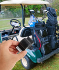 Hand holding Inductive Throttle Sensor Assembly For Golf Carts in front of a golf cart with clubs, outdoor setting.