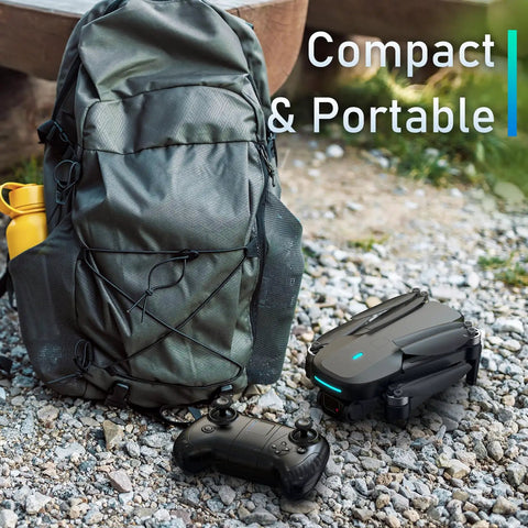 Foldable Kids Drone With 1080P HD FPV Camera Brushless Motors 2 Batteries next to a backpack on gravel