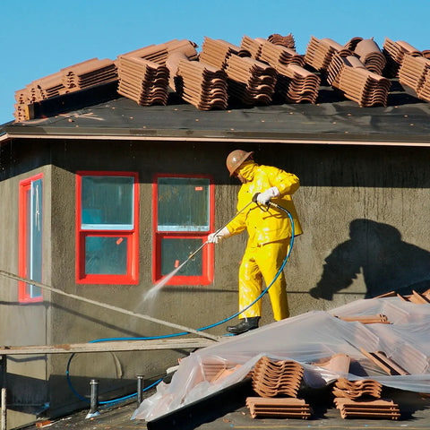 Worker in yellow suit using Eight Piece One Quarter Inch NPT Quick Connect Air Hose Fittings Kit for cleaning roof tiles