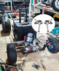 Go Kart Steering Spindle Bracket Kit With Five Eighth Inch Axle Four And A Half Inch Kingpin installed on a go-kart frame in workshop.