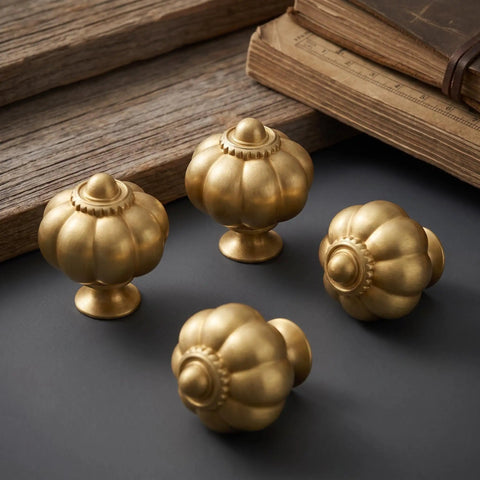 Solid Brass Cabinet Knobs And Gold Pumpkin Drawer Pulls Featuring Vintage Floral Accents For Kitchen Cupboards And Dressers Heavy Duty 6 Pack 1 1 8 Inch, four gold pumpkin cabinet knobs on a dark surface.