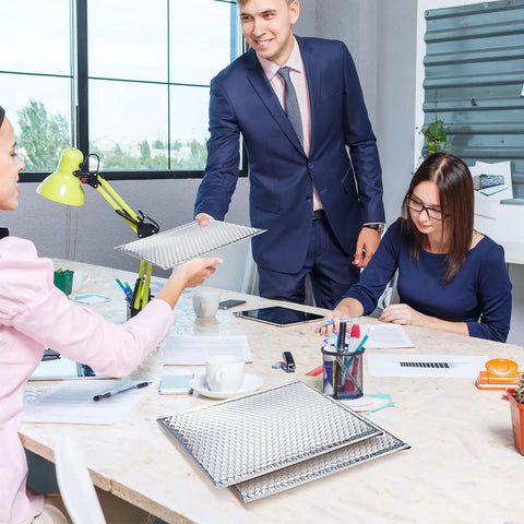 Office setting with colleagues sharing 20 Pack Thermal Bubble Mailers, 8 By 11 Inches, Silver Metallic Self Seal Foil Mailing Envelopes.