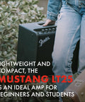 Person carrying Mustang LT25 Guitar Amplifier 25 Watt Digital Modeling Combo Amp With 8 Inch Speaker, outdoors