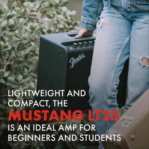 Person carrying Mustang LT25 Guitar Amplifier 25 Watt Digital Modeling Combo Amp With 8 Inch Speaker, outdoors