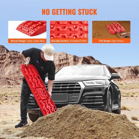 Person using Long Red 10 Ton Traction Boards For Off Road Adventures, Beefy Heavy Duty Recovery Mats Made Of PP Material near SUV