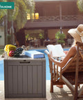 31 Gallon Outdoor Storage Deck Box With Lockable Lid Waterproof Resin Construction near poolside with fruit and book on top