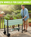 Galvanized Raised Garden Bed On Legs With Wheels For Easy Mobility in use on a deck, elevated planter box with plants