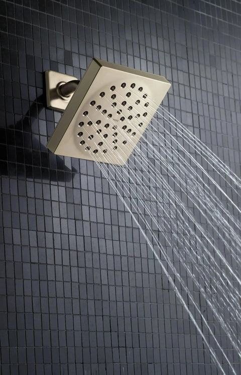 Eco-Performance Six-Inch Rain Showerhead With Immersion Technology, Self-Pressurizing One-Function Spray For A Thunderous Rinse Delivers Three Times More Spray Power, 2.0 GPM WaterSense Chrome Finish mounted on black tile wall spraying water