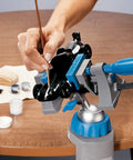 3 in 1 Multi Vise Attachment for Dremel Rotary Tool Stationary Vise holding small craft piece on wooden table