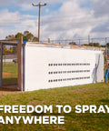 Tough As Nails 18V Cordless Airless Paint Sprayer With Advanced HEA Tech being used to paint a fence.