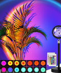 Sunset Lamp With Remote And 360 Degree Rotation, RGB Multicolor Projection Night Light casting light on palm leaves