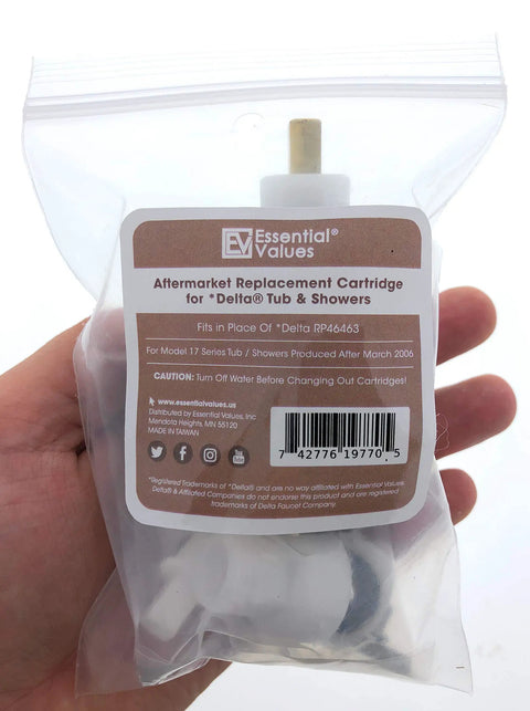 Hand holding Delta Monitor RP46463 Replacement Cartridge For 17 Series Faucets in clear packaging.
