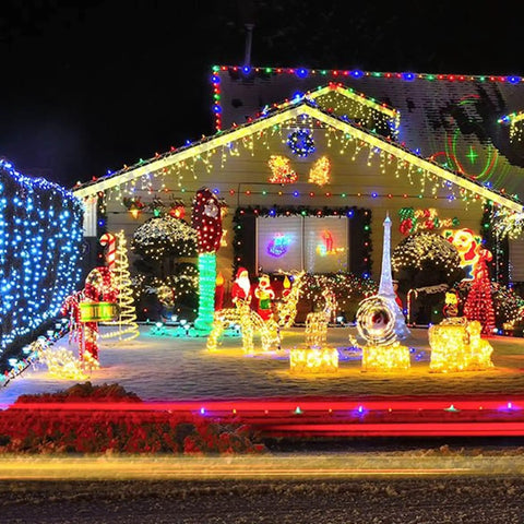 Festive house adorned with Warm White Christmas String Lights, 20 Ft, 100-Count Incandescent White Wire Lights for outdoor decor.