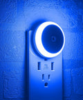 Blue LED Night Light Plug In Dusk To Dawn Sensor Small Round Nightlight Energy Saving Wall Light for bathroom and travel, plugged in.