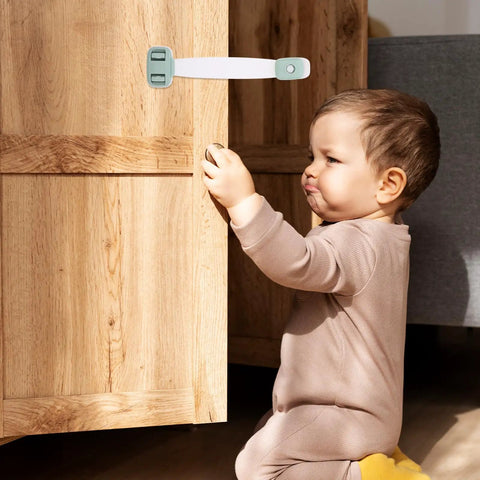 Child next to cabinet with Five Pack ABS Safety Cabinet Locks With Double Press Buckles And 360 Degree Rotation For Drawers And Refrigerator Doors
