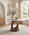 Built Tough 47 Inch Round Dining Table With White Sintered Stone Top And Legit Smooth Rotating Lazy Susan For Chowing Down With Two To Six Guests Hangout Style in modern dining room setting.
