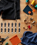 12 Piece Universal Zipper Repair Kit With Stainless Steel Sliders And Pullers For Jackets Bags Backpacks And Outdoor Gear Durable Quick Install Zipper Fasteners In Black shown with sewing tools and materials.