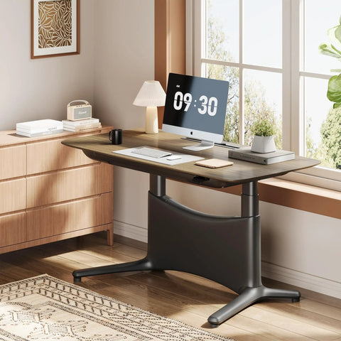 Colamy 55x28 Inch Electric Standing Desk Dual Motor Sit Stand Workstation with walnut top and heavy-duty carbon steel frame in an office setting.