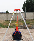 Top Shelf Boss Level Heavy Duty Emergency Rescue Tripod With 30m Winch Kickass Fall Arrest Kit For Confined Space Portable Hoist and Pulley Industrial Lifting Gear in use over a manhole.