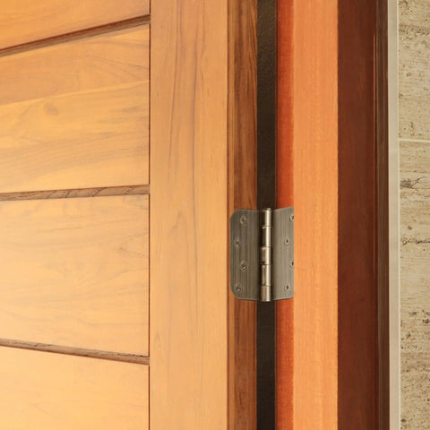 Built Thick Steel Interior Door Hinges Four Inch Antique Brass Finish Three Pack With Removable Pin For Smooth Daily Swinging And No Hassle Residential Installation on a stylish wooden door.