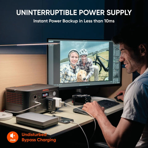 Person using Go Anywhere 512Wh LiFePO4 Portable Power Station With 500W Continuous Power And 1000W Peak at a desk for backup power.