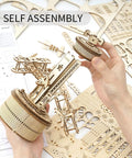 Hands assembling 3D Wooden Puzzle Mechanical Music Box Aircraft Model Kit For DIY Builders, parts and gears visible.
