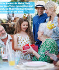 Family celebration with people wearing party crowns at outdoor gathering, young girl giving a gift to elderly woman.