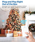 Person using Remote Control Outlet Switch For Lamps And Lights, Wireless Light Switch with On Off Remote by Christmas tree.
