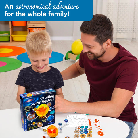 Father and child playing with Orbiting Solar System STEM Kit With Windup Motor No Batteries Needed Rotating Planets