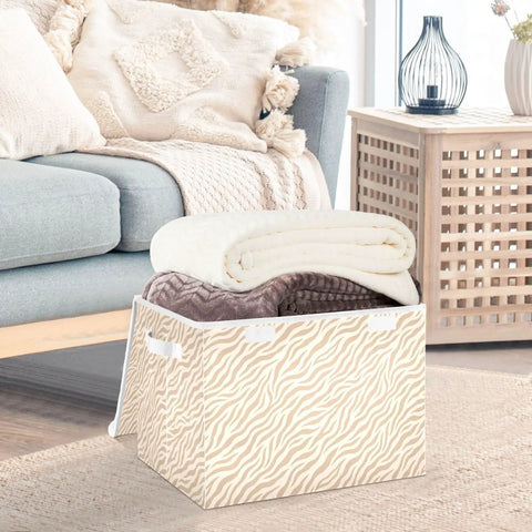 Built Tough Foldable Storage Bin With Slick Flip Top Lid And Locked Down Velcro Closure Durable Oxford Fabric Collapsible Closet Organizer For Home Bedroom No Sweat Space Savers filled with rolled blankets in a living room.