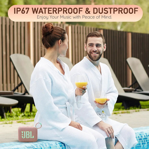 Couple in robes sitting poolside with glasses, Go 4 Portable Bluetooth Speaker with IP67 Waterproof and Dustproof Build visible.