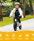 Electric Balance Bike For Kids 12 Inch Pneumatic Tires With 150W Peak Motor And 24V Battery 6 Mile Range Suspension Fork Adjustable Seat Kid Friendly Learn To Ride Toy For Ages 3 To 8 on a child riding uphill