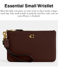 Top Shelf Small Wristlet Crafted From Smooth Pebble Leather With Signature Hardware And Detachable Strap For Phone Cash Cards Everyday Carry Clean Fit Women Fashion Clutch Case in burgundy view with wrist strap.