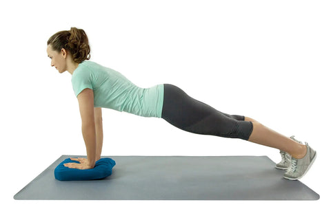 Woman performs plank exercise using Teeter Core Restore Inflatable Lumbar Support Cushion for back pain relief.