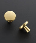 30 Pack Solid Kitchen Cabinet Round Knobs And Dresser Pulls Gold Brushed Brass Cupboard Hardware For Doors And Drawers One And One Quarter Inch Top Diameter Beefy Heavy Duty Build For Long Lasting Use, viewed from above and side on black surface