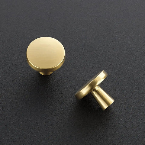 30 Pack Solid Kitchen Cabinet Round Knobs And Dresser Pulls Gold Brushed Brass Cupboard Hardware For Doors And Drawers One And One Quarter Inch Top Diameter Beefy Heavy Duty Build For Long Lasting Use, viewed from above and side on black surface