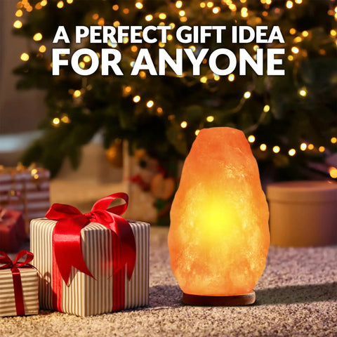 Himalayan Glow Natural Pink Salt Lamp Hand Mined In The Himalayan Mountains Crystal Night Light With ETL Brightness Dimmer Switch Wooden Base 6 To 8 Lbs Salt Lamp Calming Amber Glow Gift Box Included displayed next to wrapped gifts.