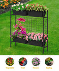 Vertical Raised Garden Bed With Trellis And Legs For Patio Balcony Outdoor Planter Box For Herbs Flowers And Vegetables Elevated Climbing Plant Bed 32.4 Inch High Black, assembled with flowers on grass.