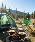 Four Pack Mini Cast Iron Skillets 4 Inch With Double Drip Spouts cooking eggs on outdoor grill by tent and chairs.