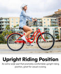Woman riding bike with Ultra Comfy Cruiser Bike Seat For Men And Women With Plush Foam Cushion on boardwalk, cityscape background