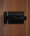 Heavy Duty Swinging Door Latch For Interior And Exterior Use With WeatherGuard Protection In Black installed on wooden door